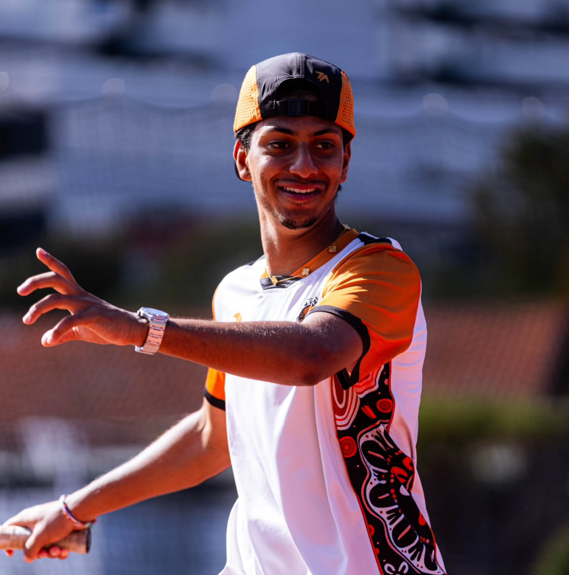 Curtin tennis player wearing the club shirt and cap