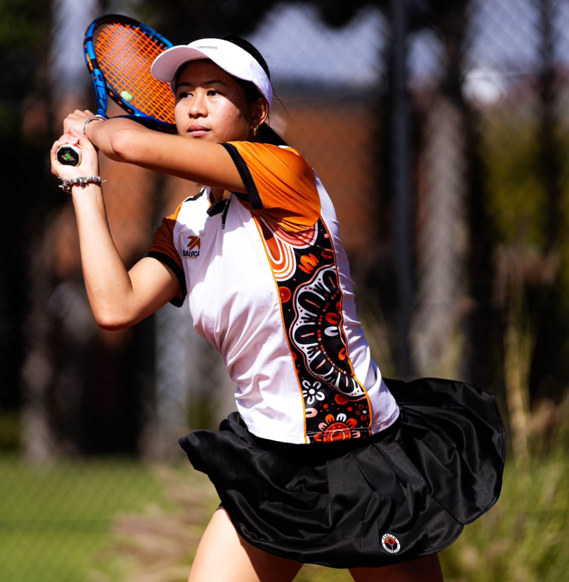 Curtin tennis player preparing a shot in the club shirt and skirt