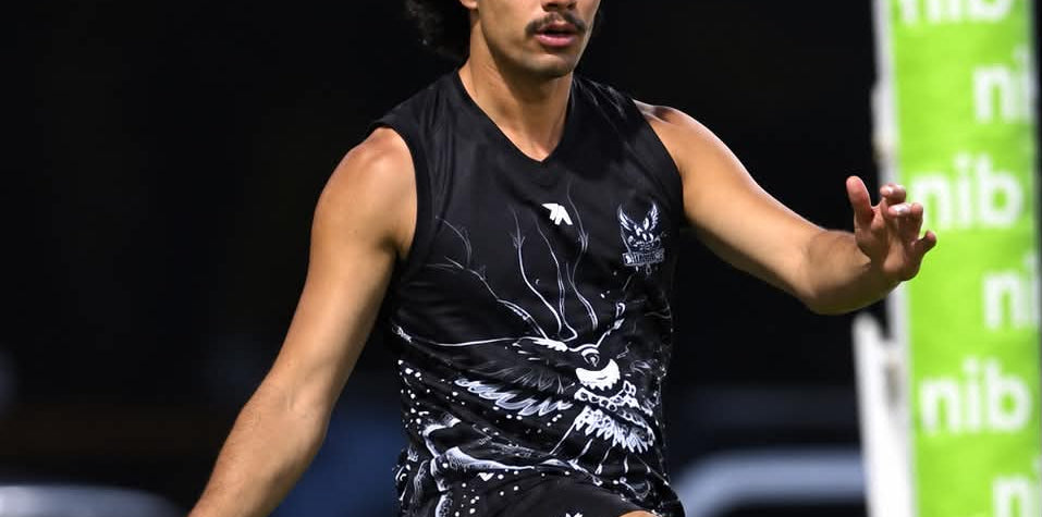 Koolbardis footballer in action wearing the black and white Dialocal Active guernsey and shorts